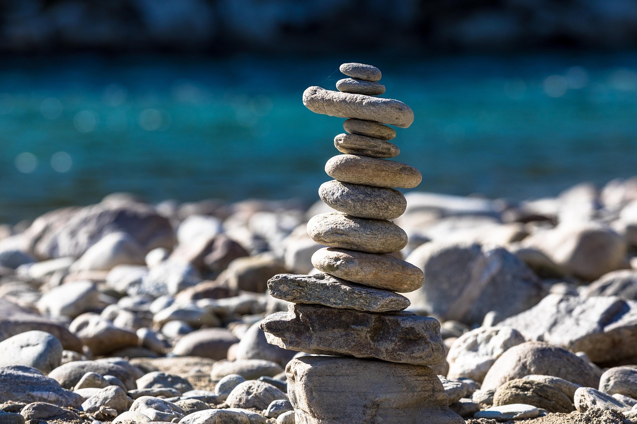 A stack of pebbles on a beach balancing to represent a balanced approach to governance